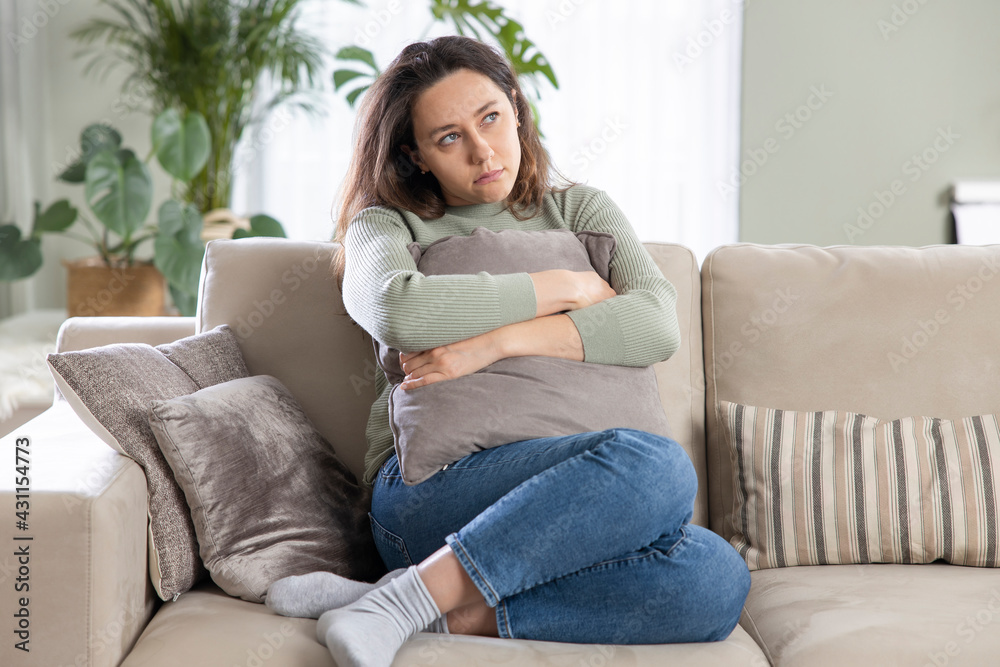Depressed young woman on sofa at home. Depressed young woman on sofa at home.