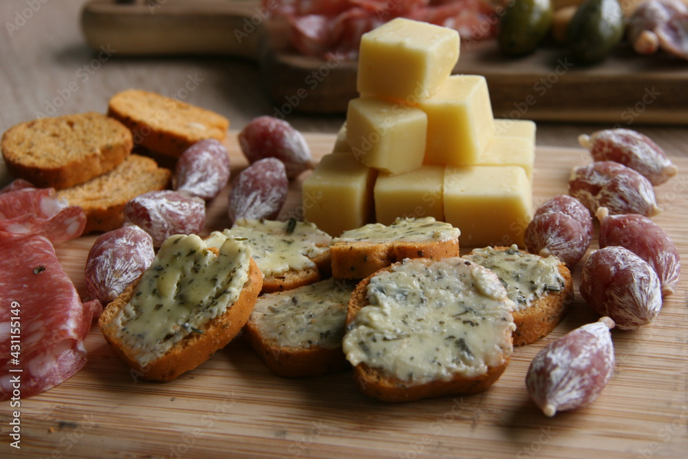 Antipasti dish with bread, garlic butter, cheese and sausage