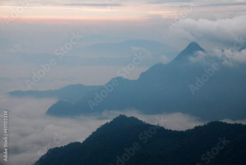 Landscape Nature scene landscape of Fog and Misty in the valley with light of sunrise in the morning of winter season at Phu Chi Fa , Chiangrai , Thailand 