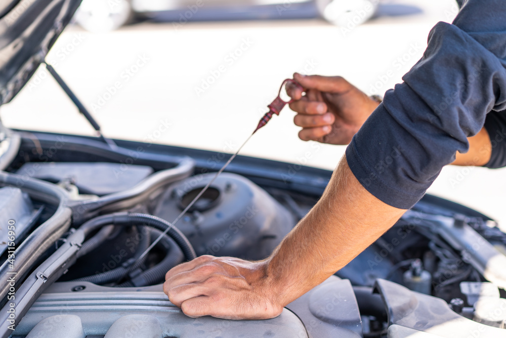 Young caucasian man trying to repair a breakdown in his car Young caucasian man trying to repair a breakdown in his car