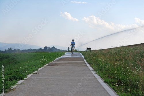 Sport activity ride bicycle on bicycle lane in the parks with Cloud blue sky at singha park , chiang rai , thailand - Travel park and Outdoor 