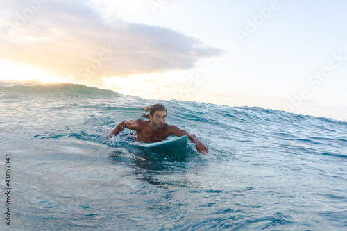 Young caucasian man get up early to  doing surf at sunrise