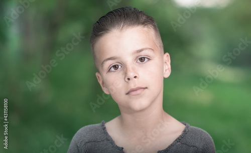 happy boy posing outside.portrait of a child looking straight into the camera
