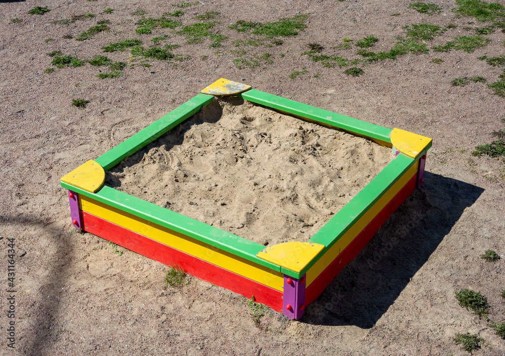 An empty children's sandbox in the courtyard of high-rise buildings.