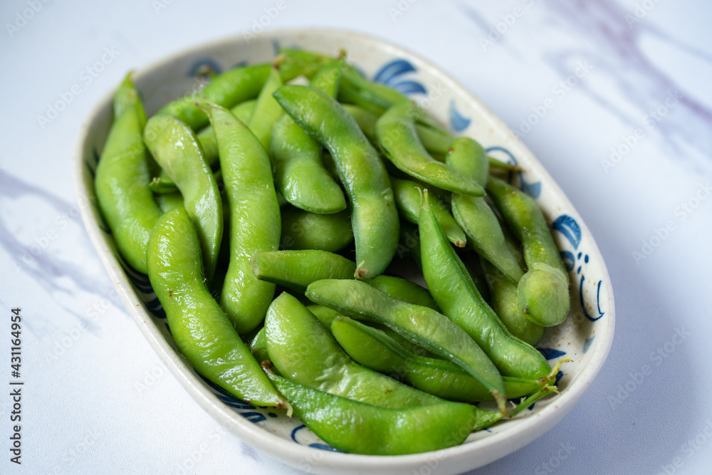 Japanese food edamame nibbles, boiled green soy beans Japanese food edamame nibbles, boiled green soy beans