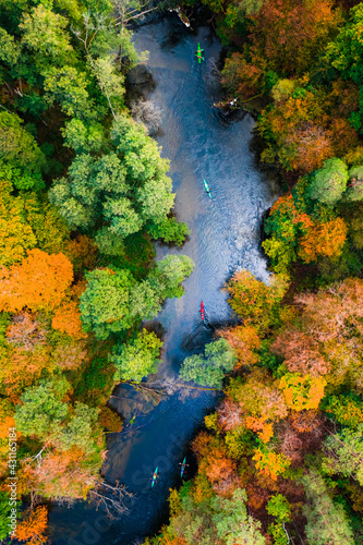 Kayaking on river in in autumn. Aerial view on wildlife