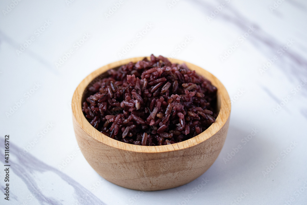 Close-up. Riceberry rice in a wooden bowl. Close-up. Riceberry rice in a wooden bowl.