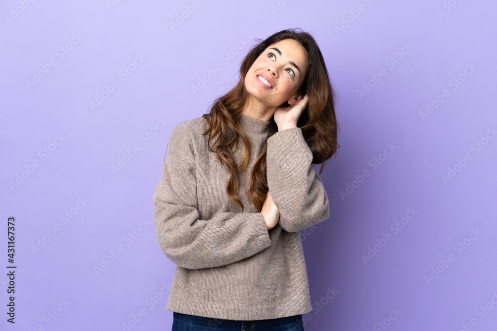 Woman over isolated purple background thinking an idea Woman over isolated purple background thinking an idea