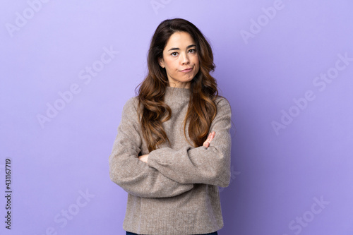 Woman over isolated purple background feeling upset