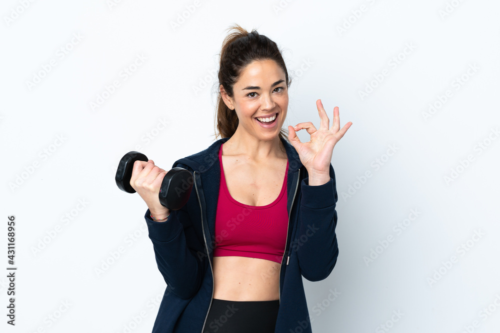Sport woman making weightlifting over isolated white background showing ok sign with fingers Sport woman making weightlifting over isolated white background showing ok sign with fingers