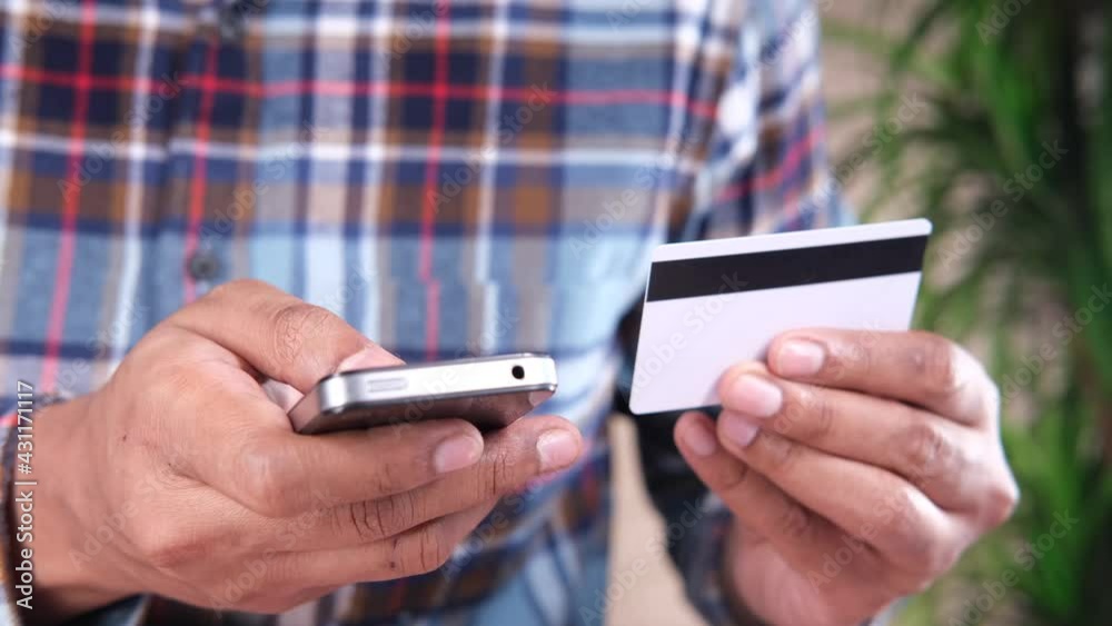 Man hand holding credit card and using smart phone shopping online Man hand holding credit card and using smart phone shopping online