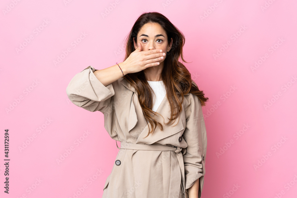 Woman over isolated background covering mouth with hand Woman over isolated background covering mouth with hand