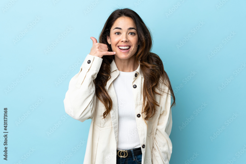 Woman over isolated background making phone gesture. Call me back sign Woman over isolated background making phone gesture. Call me back sign