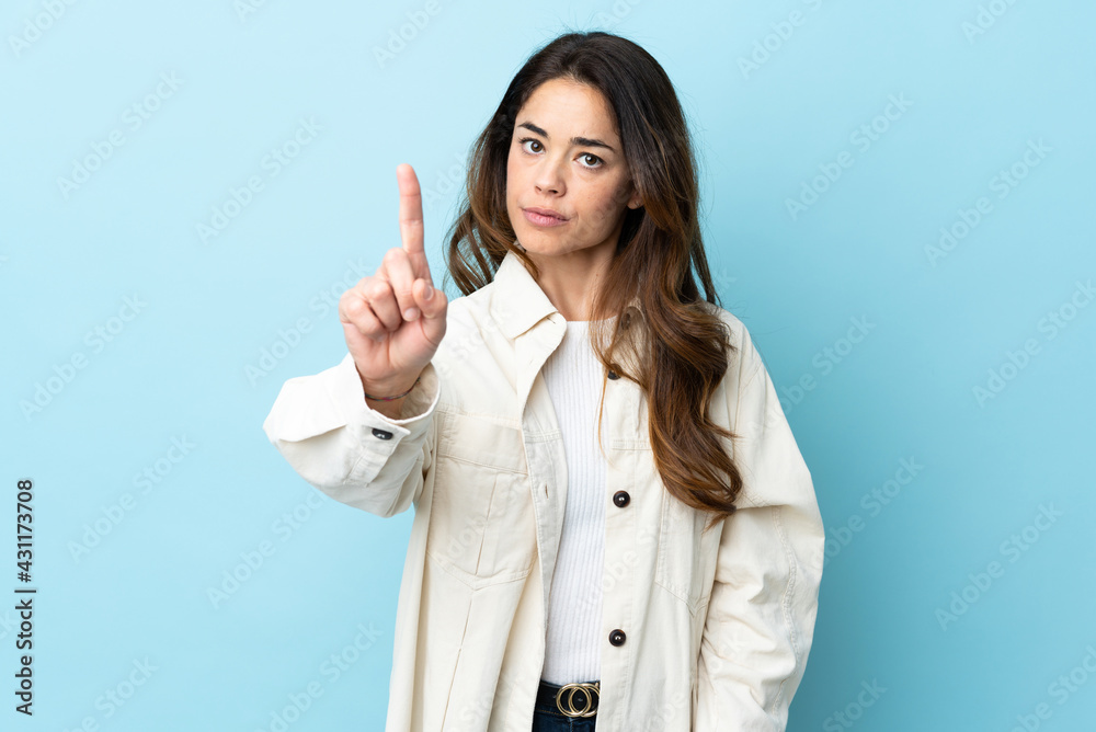 Woman over isolated background counting one with serious expression Woman over isolated background counting one with serious expression