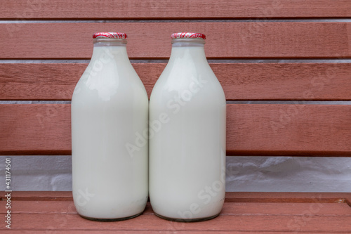 Two glass milk bottles on a doorstep