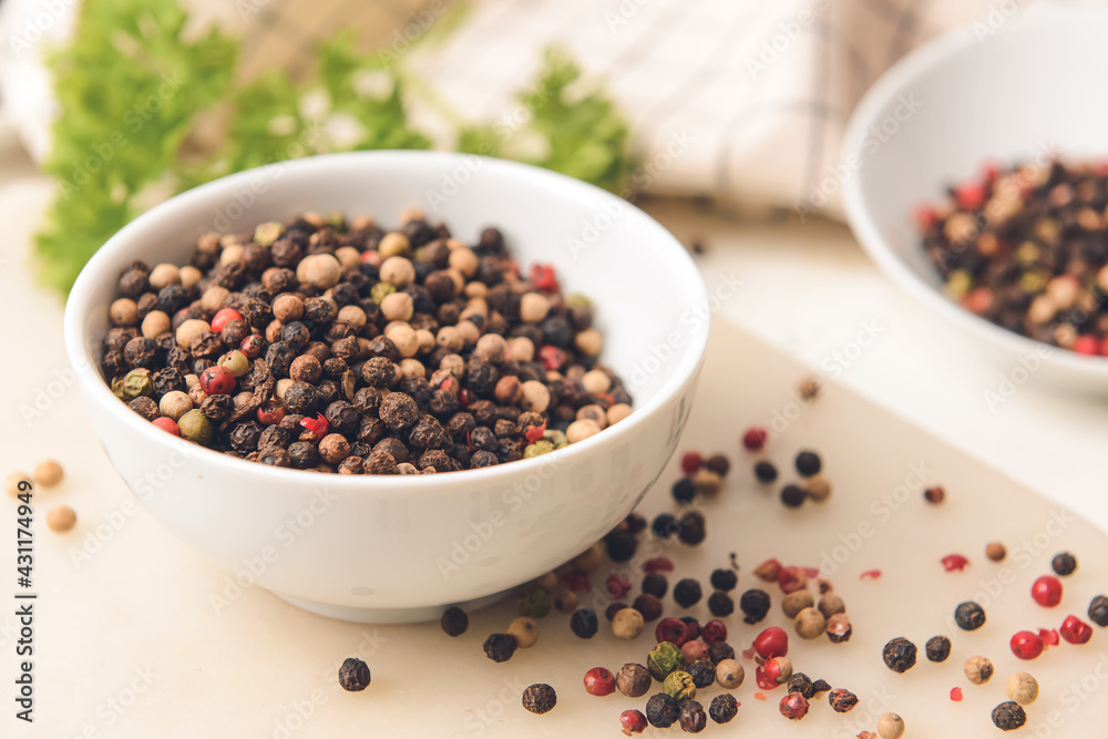 Bowl with peppercorns on light background Bowl with peppercorns on light background