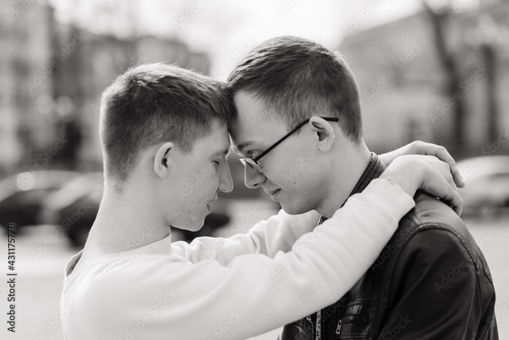 Young gay couple smiling happy and hugging at the city. Young gay couple smiling happy and hugging at the city.