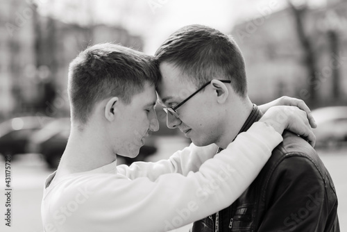 Young gay couple smiling happy and hugging at the city.