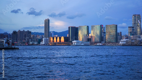 Hong Kong - June 25, 2016: sunset view in Hong Kong, Kow Loon district, Central district in Hong Kong. Victoria Harbour. Illustrative editorial , city skyline at sunset © Lesia Povkh