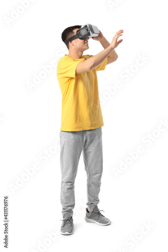 Young man with virtual reality glasses on white background © Pixel-Shot