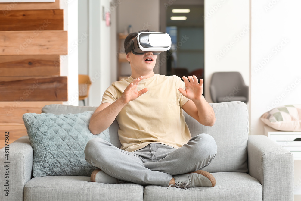 Young man with virtual reality glasses at home Young man with virtual reality glasses at home