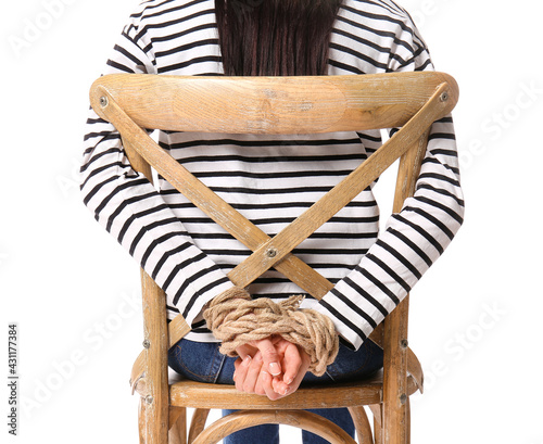 Female hostage sitting on chair against white background photo