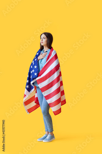 Sad young woman with USA fl...