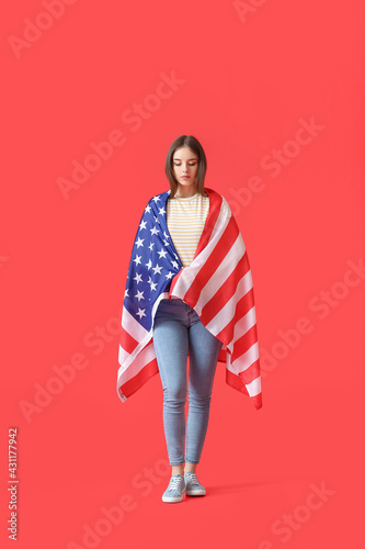 Sad young woman with USA fl...