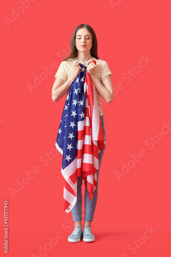 Sad young woman with USA fl...