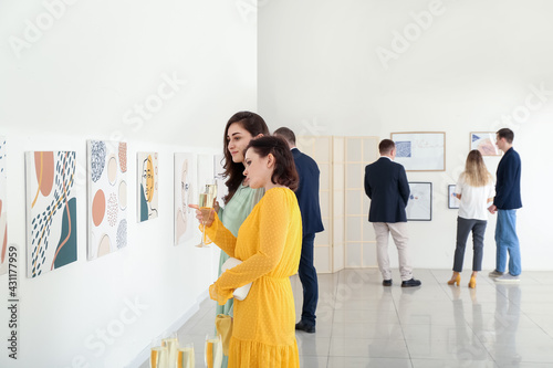 People at exhibition in modern art gallery photo