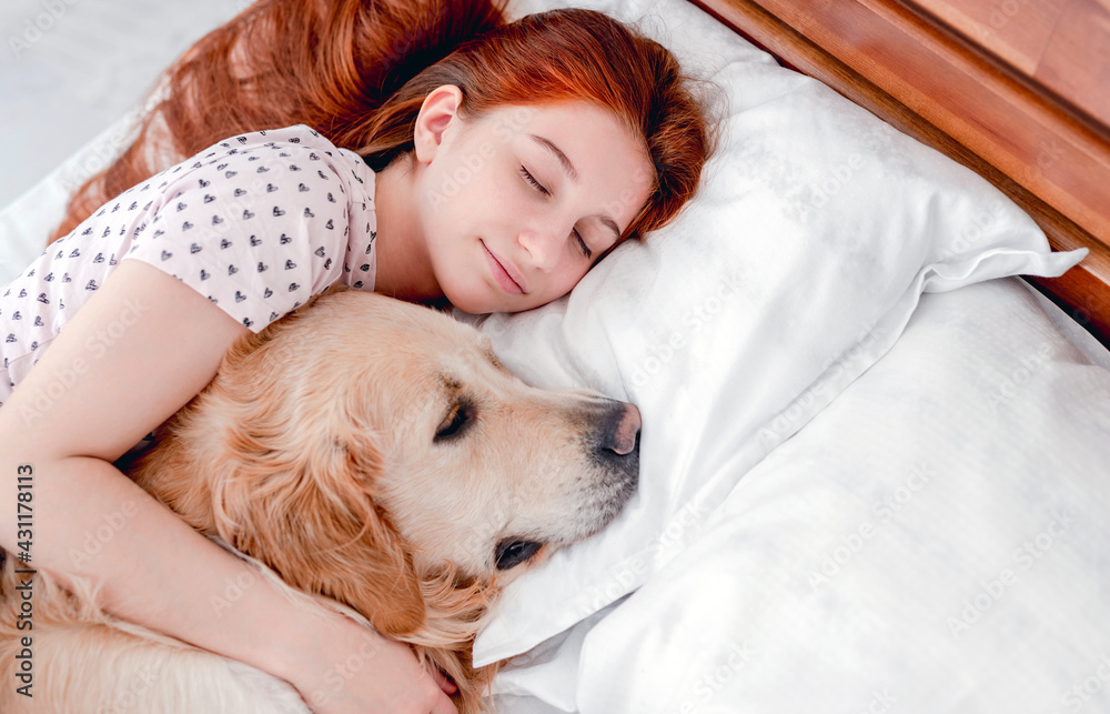 Girl with golden retriever dog in the bed Girl with golden retriever dog in the bed