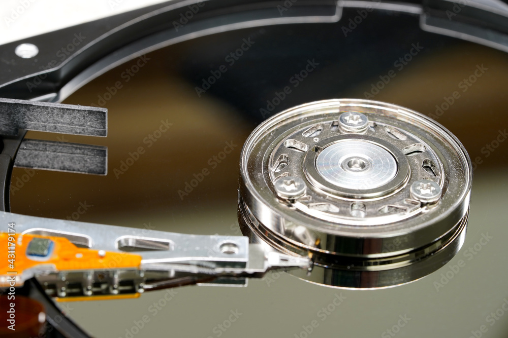 Hard disk spindle and recording head close-up. Computer detail, data recording and information storage. Storage device Hard disk spindle and recording head close-up. Computer detail, data recording and information storage. Storage device