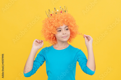 fancy party look. egocentric kid in clown wig and crown. imagine herself a princess.