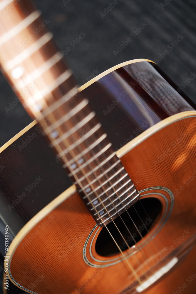 Abstract background of musical stringed instruments. Wood. Sound wave. Classical guitar close-up. Metal strings Abstract background of musical stringed instruments. Wood. Sound wave. Classical guitar close-up. Metal strings