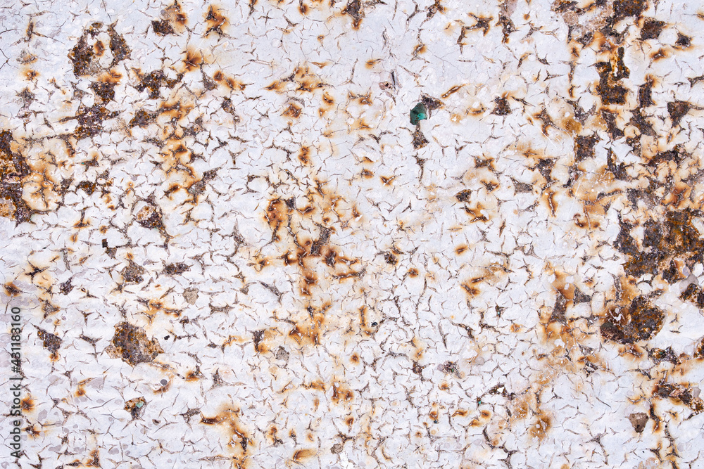 The texture of old rusty metal covered with cracked paint The texture of old rusty metal covered with cracked paint