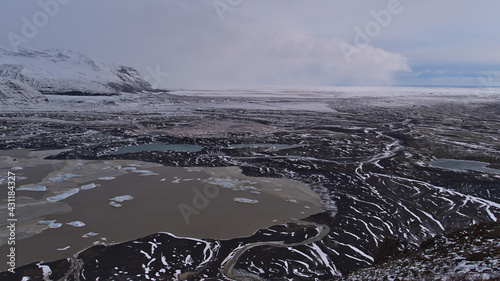 Panoramic view over the glacier lagoon of Skaftafellsjökull with floating icebergs in the south of Iceland in Skaftafell national park with the sparse landscape of Öræfasveit in winter season. photo
