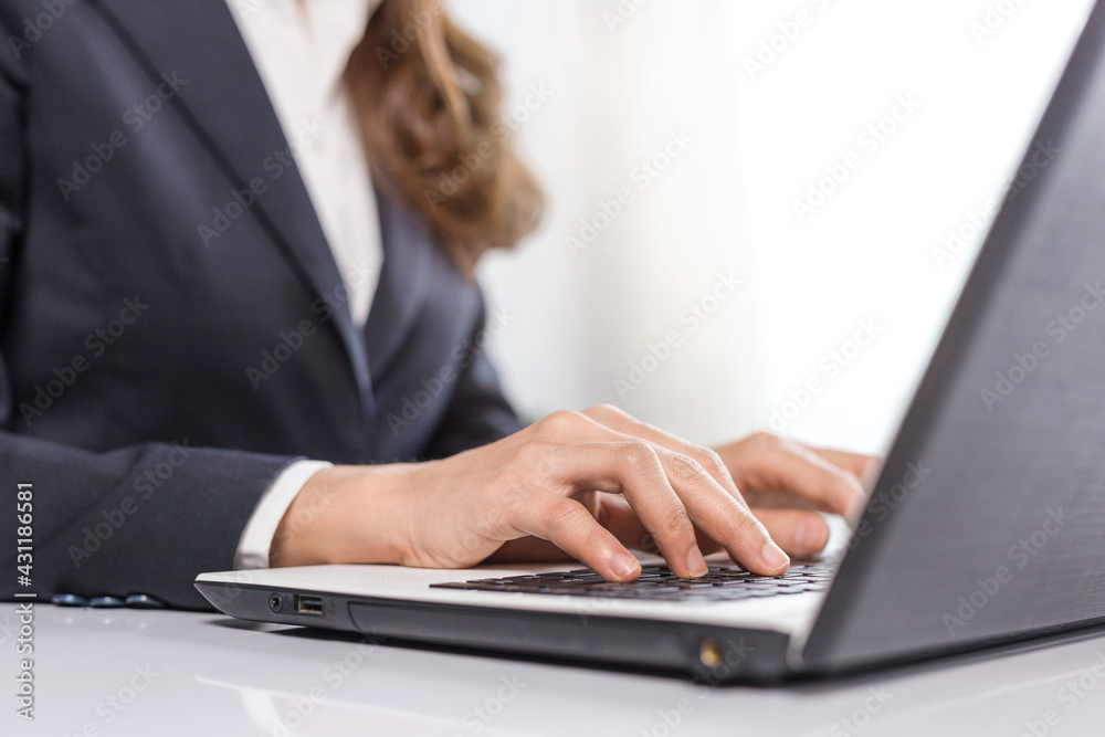 Female business hands typing on laptop computer, close-up Female business hands typing on laptop computer, close-up