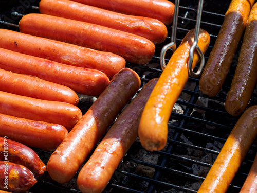 Top view of many  hotdogs on a grill