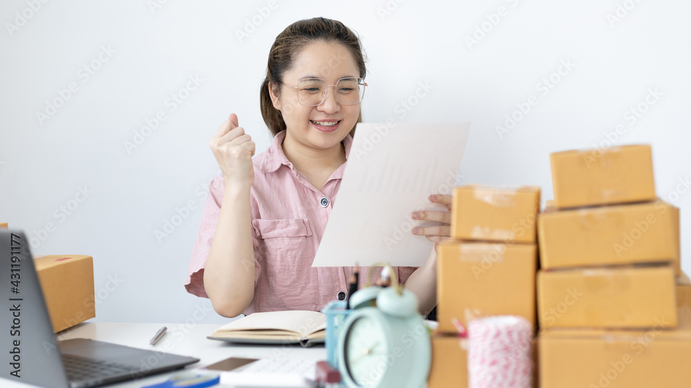Young woman was happy after receiving an order from an internet customer, New business style for young people working at home and owning businesses, Sell online or Online sell concept. Young woman was happy after receiving an order from an internet customer, New business style for young people working at home and owning businesses, Sell online or Online sell concept.