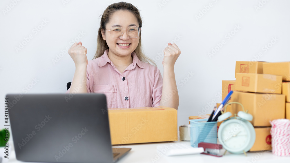 Young woman was happy after receiving an order from an internet customer, New business style for young people working at home and owning businesses, Sell online or Online sell concept. Young woman was happy after receiving an order from an internet customer, New business style for young people working at home and owning businesses, Sell online or Online sell concept.