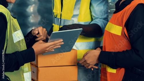 Warehouse worker working together in the storehouse . Logistics , supply chain and warehouse business concept . photo