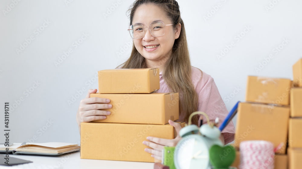 Young woman was happy after receiving an order from an internet customer, New business style for young people working at home and owning businesses, Sell online or Online sell concept. Young woman was happy after receiving an order from an internet customer, New business style for young people working at home and owning businesses, Sell online or Online sell concept.