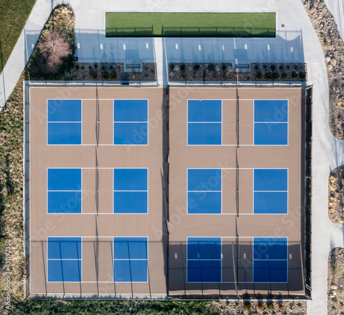 Overhead aerial of multiple pickle ball fields with some landscaping around them.
