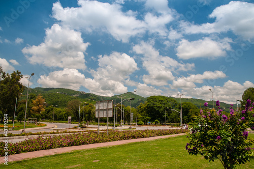 9th avenue highway road, Islamabad, fountains running, margalla hills in front, margalla road, road signs,