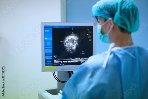 doctor used Intravascular ultrasound imaging (IVUS) machine at cardiac catheterization laboratory room
