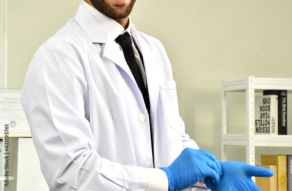 A doctor with blue grove before diagnosis the patient in hospital ward. A doctor with blue grove before diagnosis the patient in hospital ward.