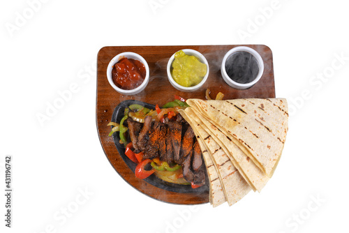 Meat Fajita: A delicious meat dish with vegetables. meat fajita on white background and shadow on wooden plate top view
