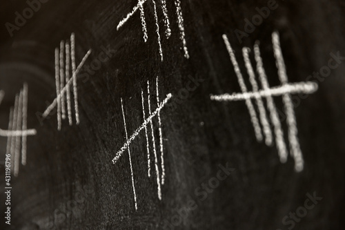 Counting with lines on dark black chalk board
