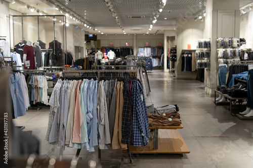 Interior of contemporary clothing store with clothes