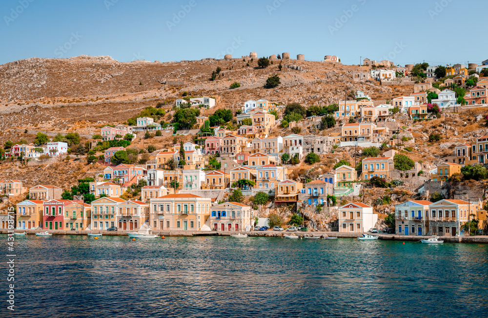 View of Symi, a village and a tiny island of Dodecanese, Greece, that amazes visitors with the calm atmosphere and its fabulous architecture.